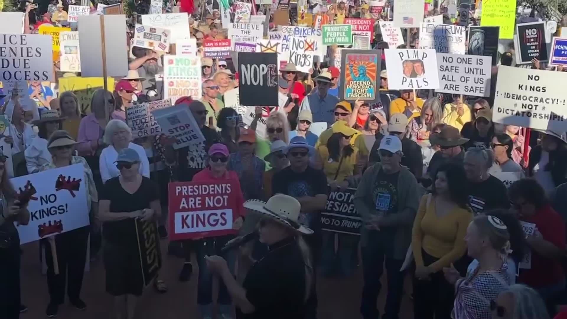 Protesters react to speakers at Tucson No Kings protest  on Saturday, Oct. 18, 2025.